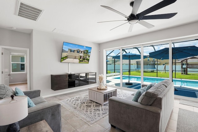 15206 Trinity Fall Way, Bradenton, FL 34212 - living room featuring a sunroom, ceiling fan, and tile patterned flooring