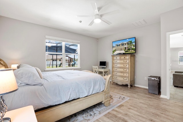 15206 Trinity Fall Way, Bradenton, FL 34212 - bedroom featuring light wood-style floors, ceiling fan, and ensuite bathroom