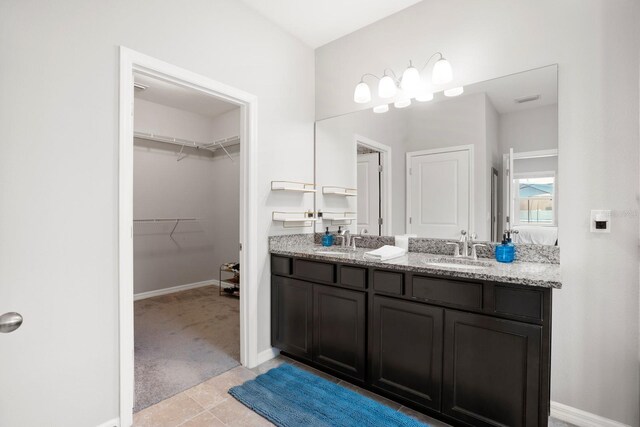 15206 Trinity Fall Way, Bradenton, FL 34212 - full bath featuring double vanity, tile patterned floors, and a spacious closet