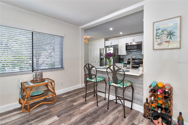 700 Starkey Rd Unit 1124, Largo, FL 33771 - dining room with dark wood-style floors, ornamental molding, and recessed lighting