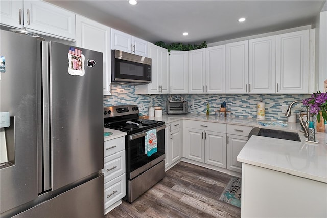 700 Starkey Rd Unit 1124, Largo, FL 33771 - kitchen featuring stainless steel appliances, dark wood finished floors, white cabinets, and recessed lighting