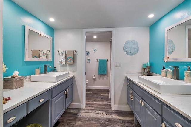 700 Starkey Rd Unit 1124, Largo, FL 33771 - bathroom with wood finished floors, two vanities, and recessed lighting