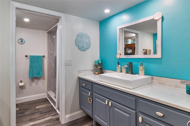 700 Starkey Rd Unit 1124, Largo, FL 33771 - bathroom featuring vanity, wood finished floors, and a tile shower