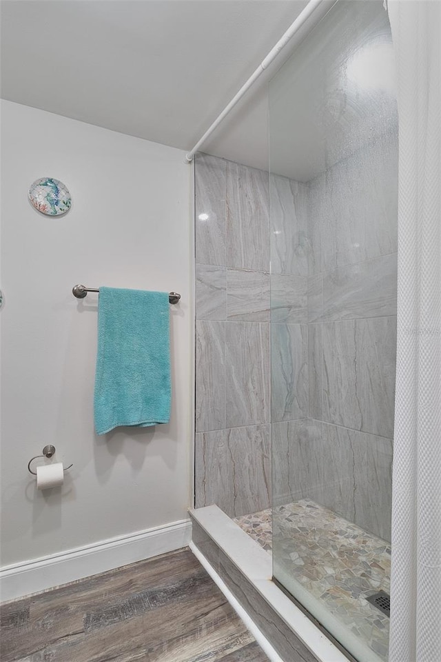 700 Starkey Rd Unit 1124, Largo, FL 33771 - bathroom with wood finished floors and a tile shower