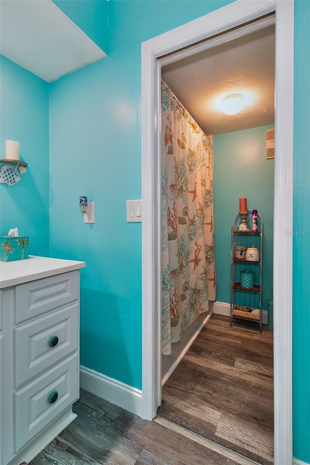 700 Starkey Rd Unit 1124, Largo, FL 33771 - full bathroom with wood finished floors, vanity, and curtained shower