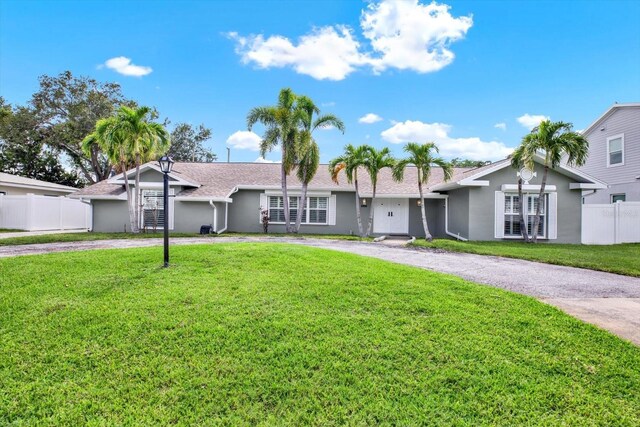 6000 115th Ln, Seminole, FL 33772 - ranch-style home featuring stucco siding and curved driveway