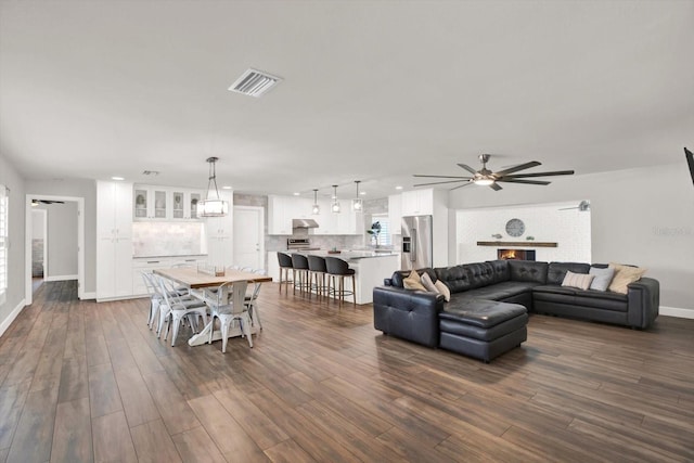 6000 115th Ln, Seminole, FL 33772 - living area featuring a ceiling fan and dark wood finished floors