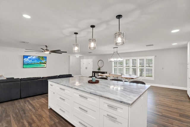 6000 115th Ln, Seminole, FL 33772 - kitchen featuring dark wood-type flooring, a ceiling fan, white cabinetry, light stone counters, and recessed lighting