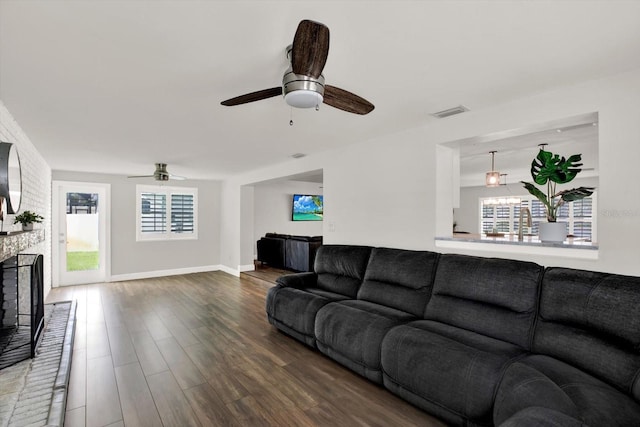 6000 115th Ln, Seminole, FL 33772 - living area with a ceiling fan, wood finished floors, and a brick fireplace