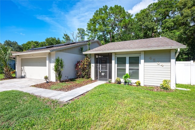 4504 Grainary Ave, Tampa, FL 33624 - view of front of home featuring roof mounted solar panels, a garage, and driveway