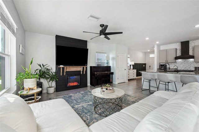 16051 Soft Fern Trce, Odessa, FL 33556 - living area featuring ceiling fan, recessed lighting, tile patterned flooring, and a glass covered fireplace