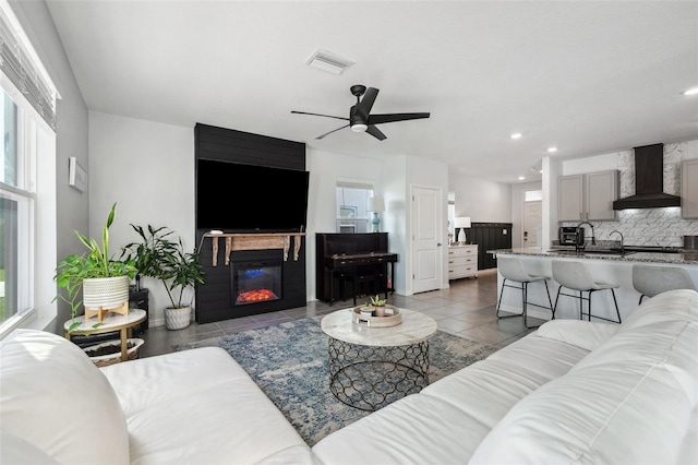 16051 Soft Fern Trce, Odessa, FL 33556 - tiled living room with ceiling fan, recessed lighting, and a glass covered fireplace