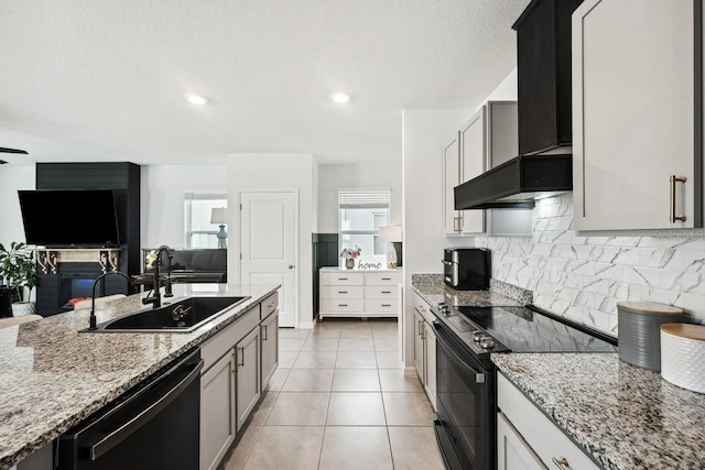 16051 Soft Fern Trce, Odessa, FL 33556 - kitchen featuring black appliances, wall chimney exhaust hood, light stone countertops, decorative backsplash, and open floor plan