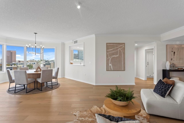 371 Channelside Walk Way Unit 1104, Tampa, FL 33602 - dining room with a chandelier, a textured ceiling, light wood-style flooring, and crown molding