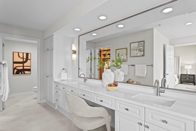 371 Channelside Walk Way Unit 1104, Tampa, FL 33602 - bathroom with double vanity, recessed lighting, a textured ceiling, and ensuite bathroom