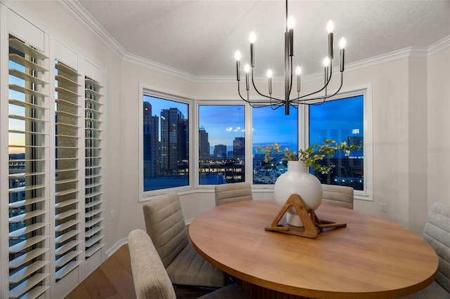 371 Channelside Walk Way Unit 1104, Tampa, FL 33602 - dining space with a chandelier, wood finished floors, ornamental molding, a textured ceiling, and a city view