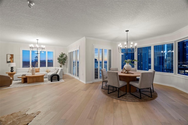 371 Channelside Walk Way Unit 1104, Tampa, FL 33602 - dining room featuring a chandelier, light wood finished floors, a textured ceiling, and crown molding