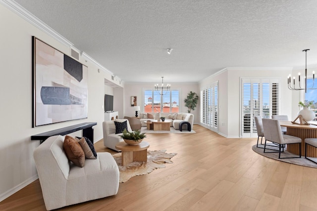 371 Channelside Walk Way Unit 1104, Tampa, FL 33602 - living area with a chandelier, crown molding, light wood-style floors, and a textured ceiling