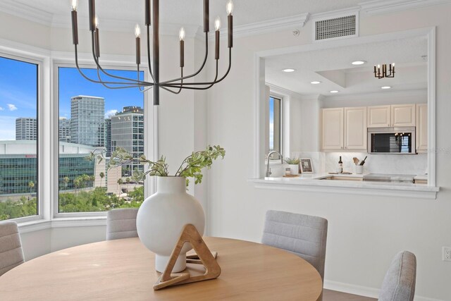 371 Channelside Walk Way Unit 1104, Tampa, FL 33602 - dining area with a chandelier, ornamental molding, a view of city, and recessed lighting