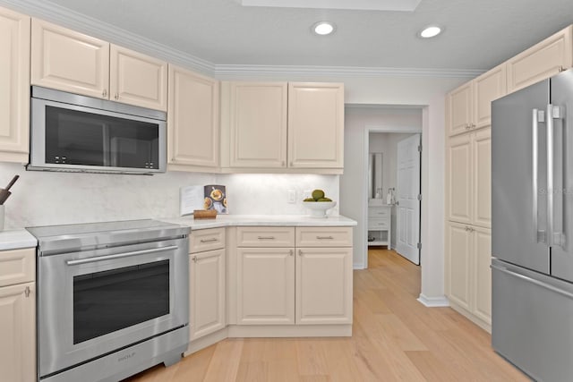 371 Channelside Walk Way Unit 1104, Tampa, FL 33602 - kitchen featuring stainless steel appliances, light wood-style floors, light countertops, recessed lighting, and ornamental molding