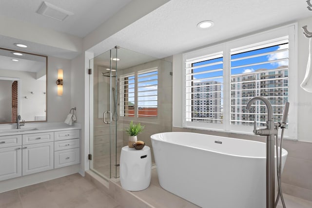 371 Channelside Walk Way Unit 1104, Tampa, FL 33602 - bathroom featuring vanity, a shower stall, a freestanding bath, recessed lighting, and a textured ceiling