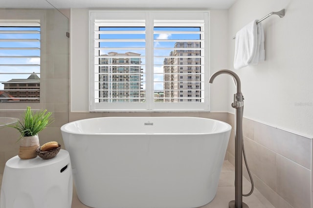 371 Channelside Walk Way Unit 1104, Tampa, FL 33602 - full bath with healthy amount of natural light, tile walls, a freestanding tub, and wainscoting