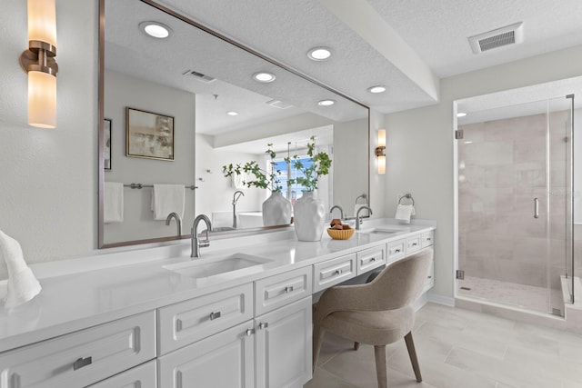 371 Channelside Walk Way Unit 1104, Tampa, FL 33602 - bathroom featuring double vanity, recessed lighting, a stall shower, and a textured ceiling