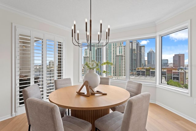 371 Channelside Walk Way Unit 1104, Tampa, FL 33602 - dining space featuring a chandelier, crown molding, a skyline view, and light wood-type flooring
