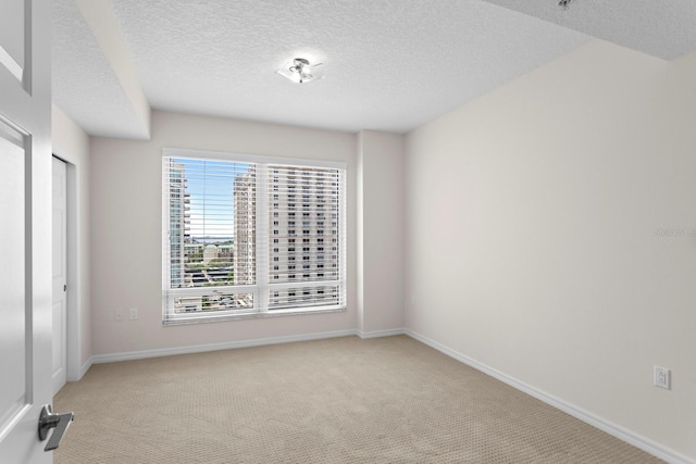 371 Channelside Walk Way Unit 1104, Tampa, FL 33602 - spare room featuring light colored carpet and a textured ceiling