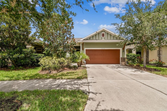6934 Old Benton Dr, Apollo Beach, FL 33572 - view of front of house with a garage, brick siding, and driveway