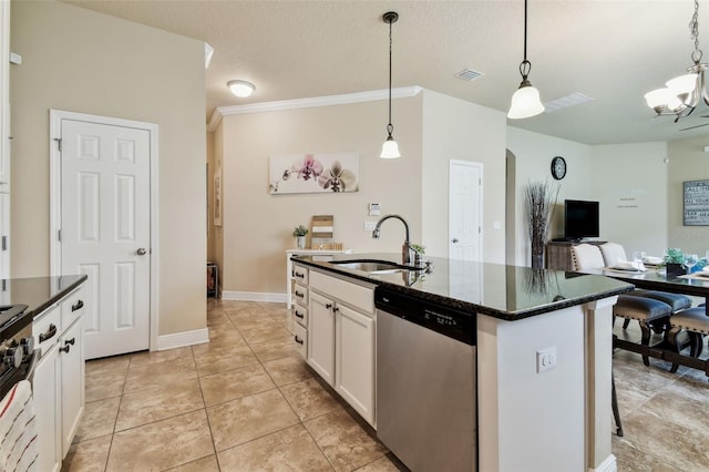 6934 Old Benton Dr, Apollo Beach, FL 33572 - kitchen featuring appliances with stainless steel finishes, open floor plan, hanging light fixtures, white cabinetry, and a center island with sink