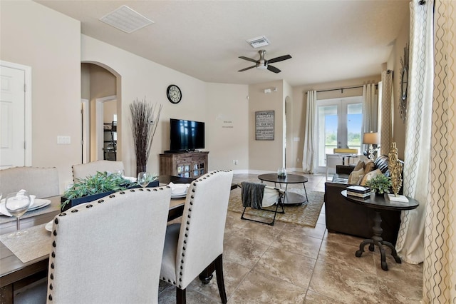 6934 Old Benton Dr, Apollo Beach, FL 33572 - dining space with arched walkways, a ceiling fan, and light tile patterned floors