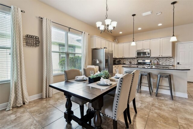 6934 Old Benton Dr, Apollo Beach, FL 33572 - dining area featuring a chandelier, recessed lighting, and light tile patterned floors