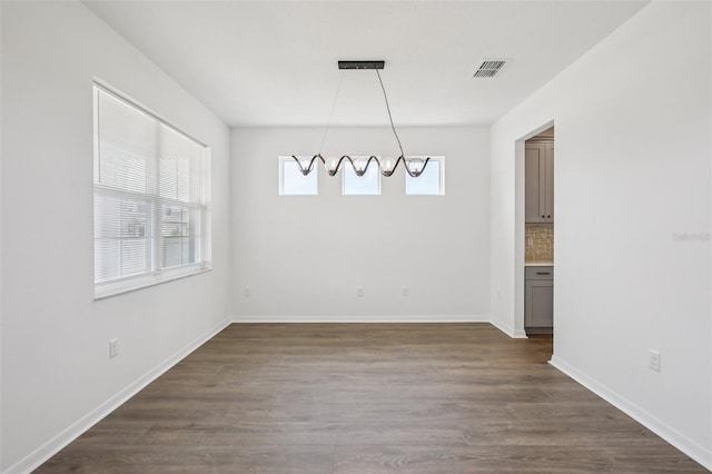 33157 Rosewood Bark Way, Wesley Chapel, FL 33545 - unfurnished dining area with dark wood-style floors and a chandelier