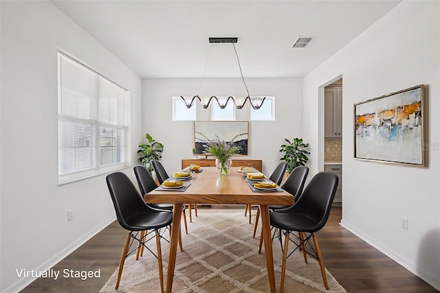 33157 Rosewood Bark Way, Wesley Chapel, FL 33545 - dining space featuring dark wood-style flooring and baseboards