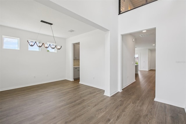 33157 Rosewood Bark Way, Wesley Chapel, FL 33545 - spare room with dark wood-style flooring and a chandelier