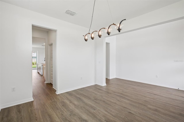 33157 Rosewood Bark Way, Wesley Chapel, FL 33545 - unfurnished dining area with dark wood-type flooring and baseboards