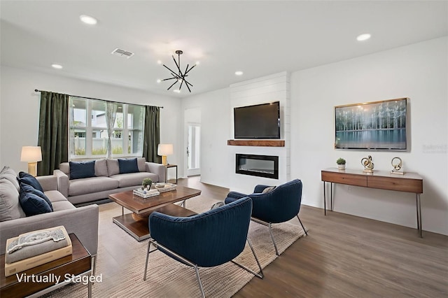 33157 Rosewood Bark Way, Wesley Chapel, FL 33545 - living area featuring a chandelier, wood finished floors, recessed lighting, and a fireplace