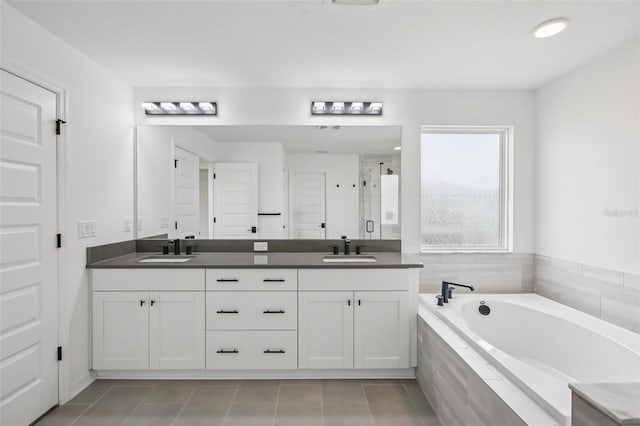 33157 Rosewood Bark Way, Wesley Chapel, FL 33545 - full bathroom with a shower stall, double vanity, a bath, and tile patterned flooring