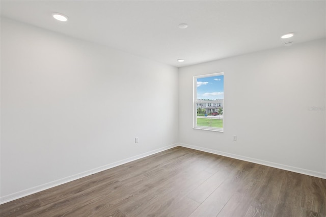 33157 Rosewood Bark Way, Wesley Chapel, FL 33545 - spare room featuring dark wood-style flooring and recessed lighting