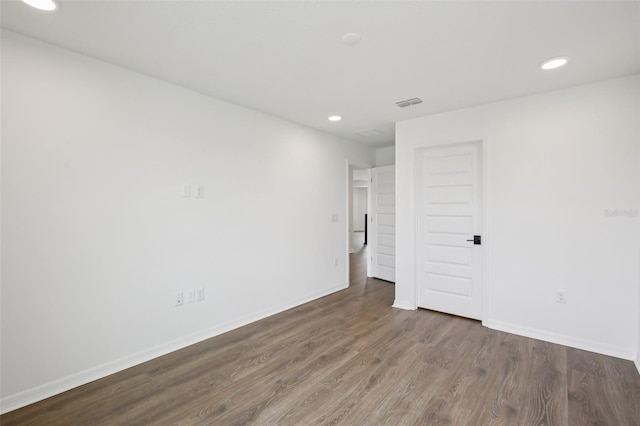 33157 Rosewood Bark Way, Wesley Chapel, FL 33545 - spare room featuring wood finished floors and recessed lighting