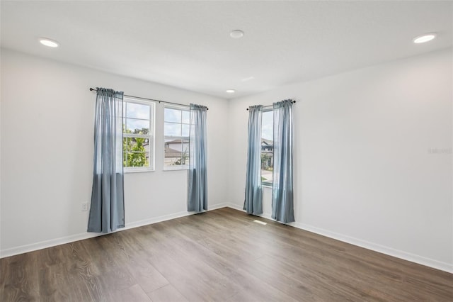 33157 Rosewood Bark Way, Wesley Chapel, FL 33545 - spare room with wood finished floors and recessed lighting
