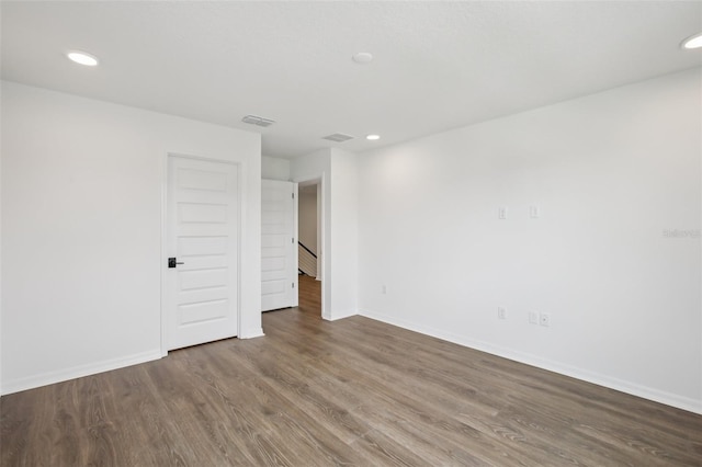 33157 Rosewood Bark Way, Wesley Chapel, FL 33545 - empty room with wood finished floors and recessed lighting
