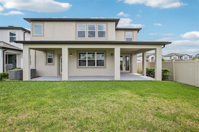 33157 Rosewood Bark Way, Wesley Chapel, FL 33545 - back of property with stucco siding and a patio area
