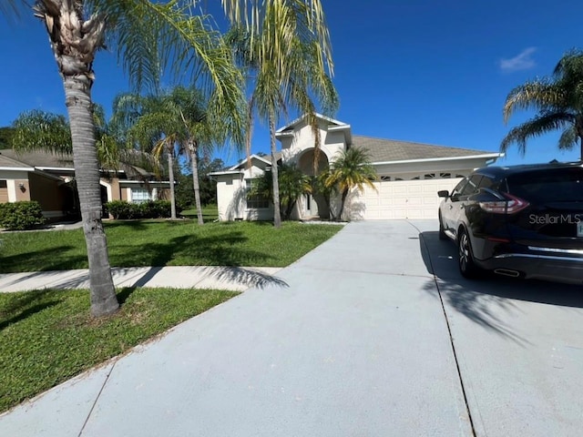 7201 Royal George Ct, Wesley Chapel, FL 33545 - single story home featuring an attached garage, concrete driveway, a front yard, and stucco siding