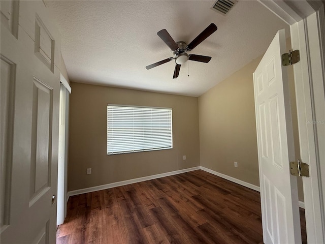 7201 Royal George Ct, Wesley Chapel, FL 33545 - unfurnished bedroom featuring dark wood-style flooring, a textured ceiling, and ceiling fan