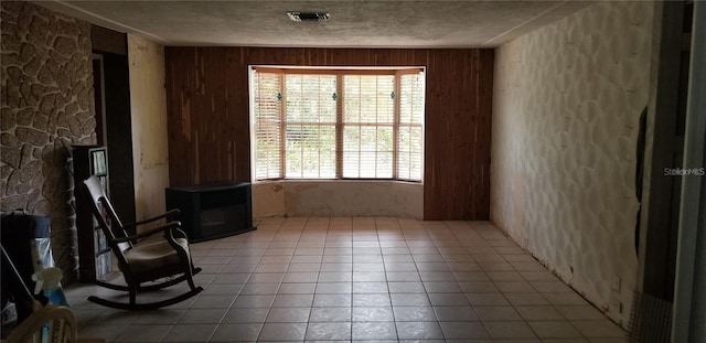 508 Dartmouth Ave E, Oldsmar, FL 34677 - spare room featuring tile patterned floors, wooden walls, and a textured ceiling