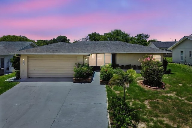 8030 San Bernardino Dr, Port Richey, FL 34668 - ranch-style house with an attached garage, concrete driveway, and stucco siding