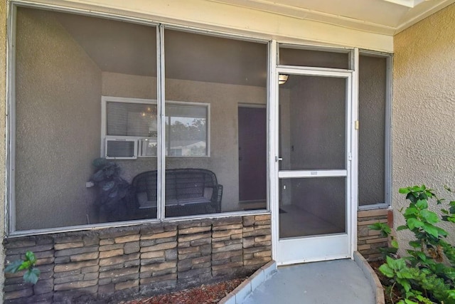 8030 San Bernardino Dr, Port Richey, FL 34668 - view of exterior entry featuring stucco siding and cooling unit