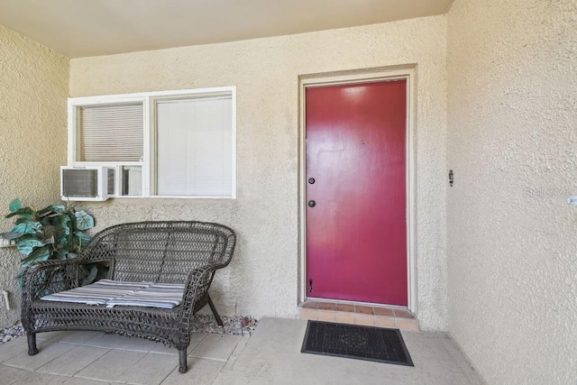 8030 San Bernardino Dr, Port Richey, FL 34668 - view of exterior entry featuring stucco siding and cooling unit
